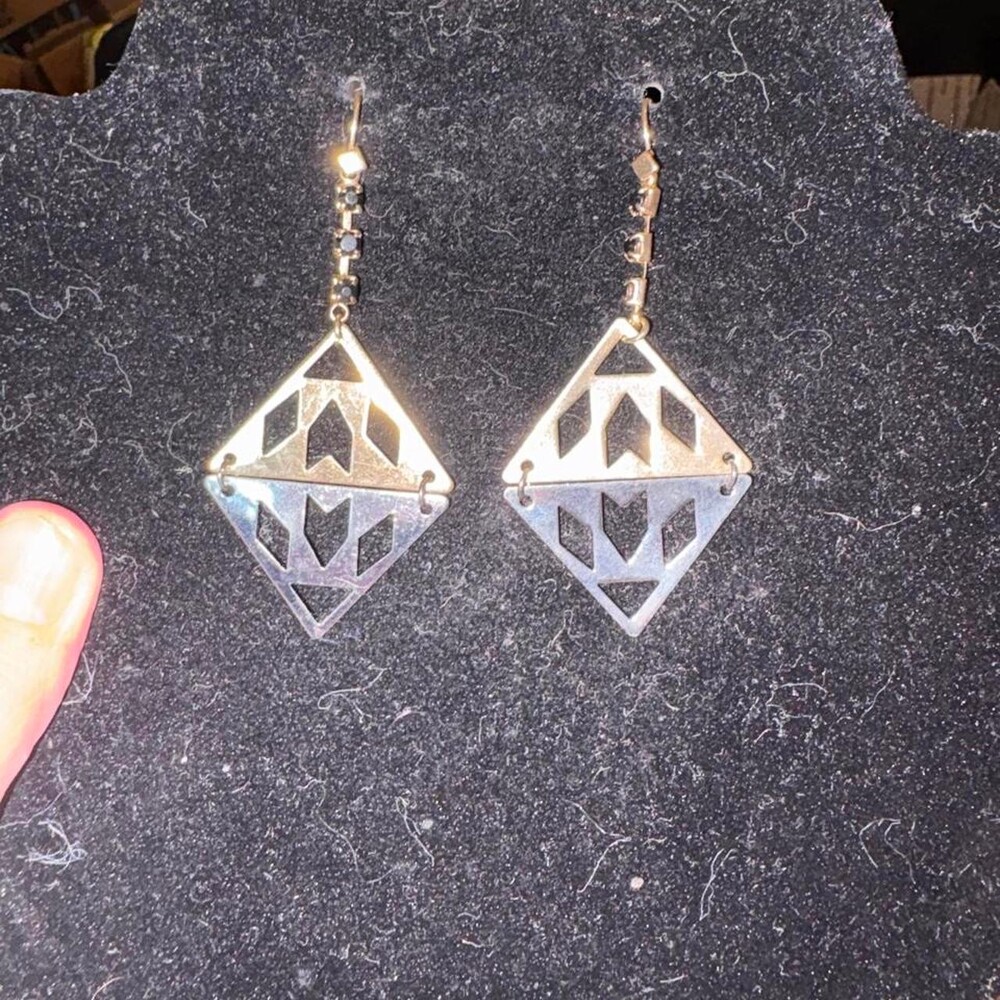 Mixed metal earrings with diamond-shaped cutout design featuring geometric shape
